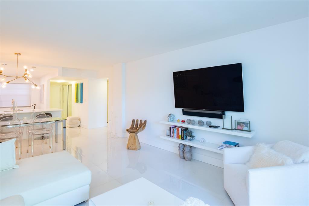 3581 South Ocean Boulevard, Unit 2B Palm Beach, FL 33480 - Photo 8 of 41 a living room with furniture and a flat screen tv
