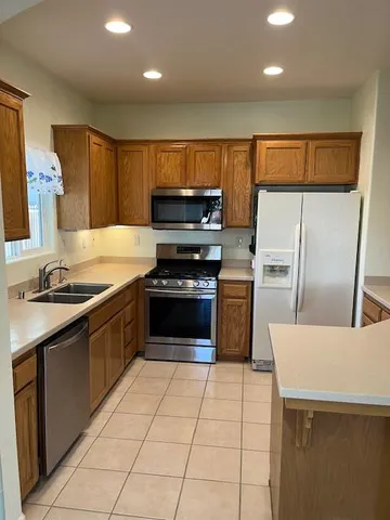 a kitchen with a sink a stove and refrigerator