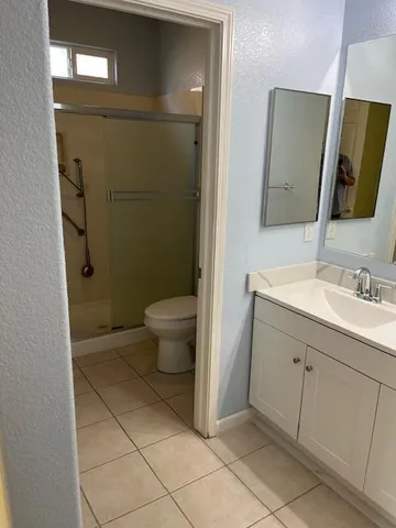 a bathroom with a sink toilet and mirror