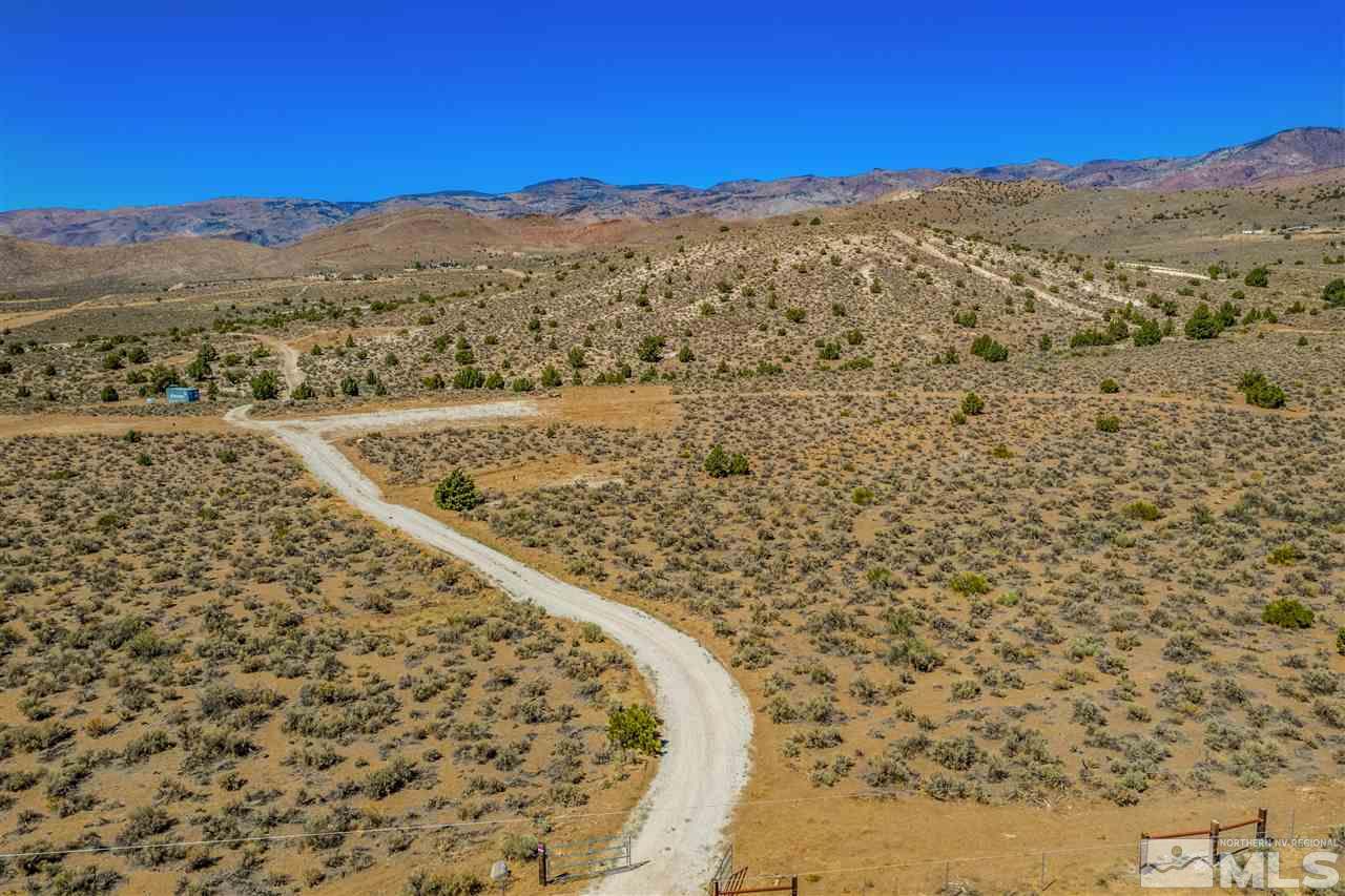 5655 Twin Springs Road Reno, NV 89510 - Photo 5 of 16 a view of a dry yard with mountains in the background