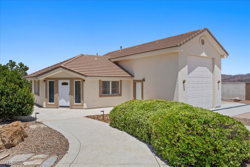 640 Quail Covey Road Henderson, NV 89002 - Photo 39 of 75 Guest Quarters with attached RV garage, a tiled roof, stucco siding, and side RV Parking