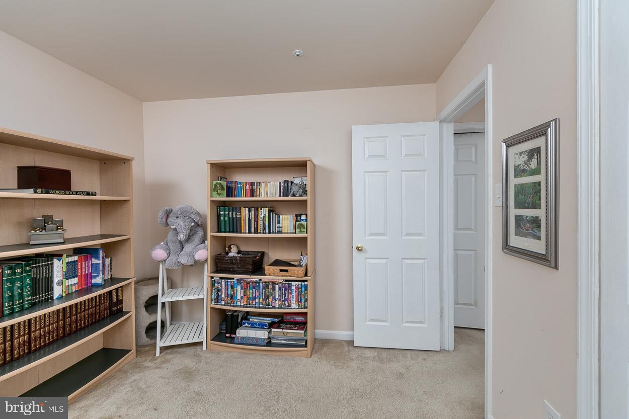 3504 Corn Stream Road Randallstown, MD 21133 - Photo 24 of 34 a room with furniture and a book shelf