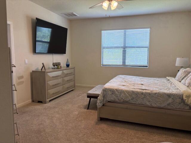 571 Old Country Rd S East Palm Bay, FL 32909 - Photo 12 of 37 a spacious bedroom with a bed and a flat screen tv