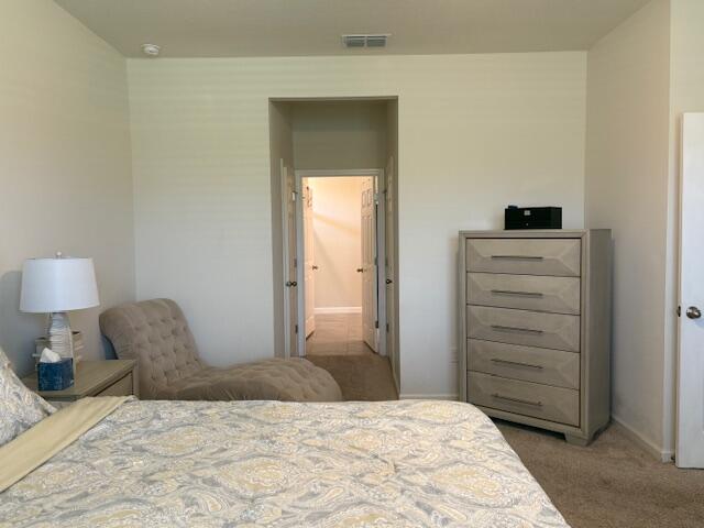 571 Old Country Rd S East Palm Bay, FL 32909 - Photo 13 of 37 a bedroom with a bed and a dresser