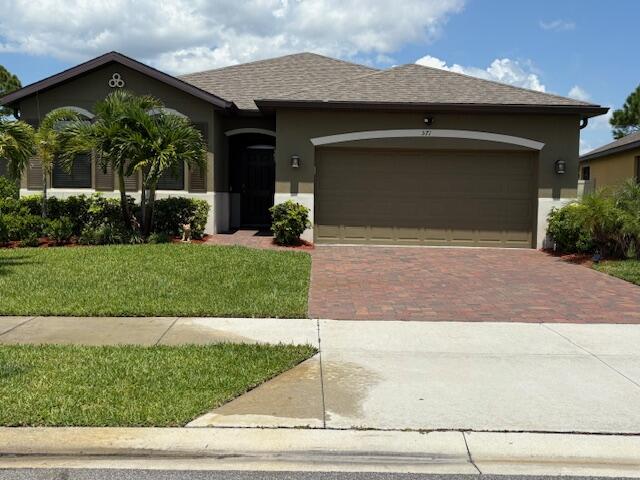 571 Old Country Rd S East Palm Bay, FL 32909 - Photo 2 of 37 a front view of a house with garage