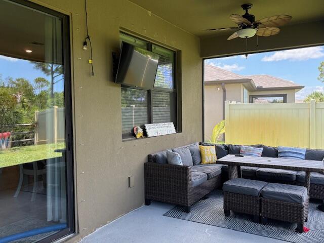 571 Old Country Rd S East Palm Bay, FL 32909 - Photo 25 of 37 a outdoor living space with furniture and a flat screen tv