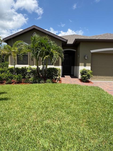 571 Old Country Rd S East Palm Bay, FL 32909 - Photo 31 of 37 a front view of a house with a yard