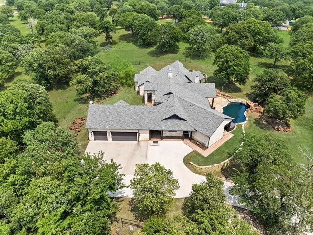 an aerial view of a house with yard swimming pool and outdoor seating
