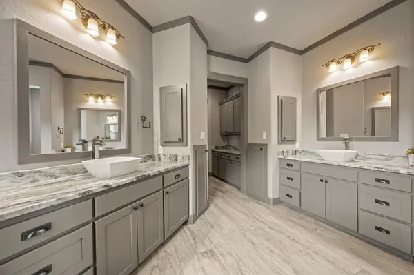 a spacious bathroom with a granite countertop sink mirror and double