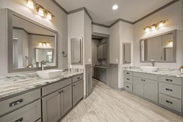 a spacious bathroom with a granite countertop sink mirror and double