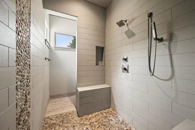 a bathroom with a glass door shower