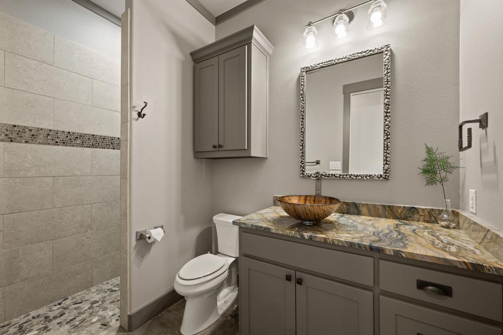 248 Howard Road Valley View, TX 76272 - Photo 19 of 39 a bathroom with a granite countertop sink and a mirror