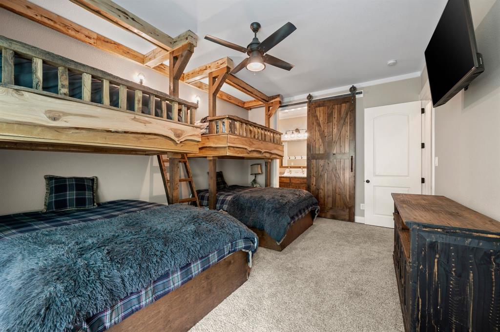 248 Howard Road Valley View, TX 76272 - Photo 21 of 39 a bedroom with bed a flat tv screen and a ceiling fan