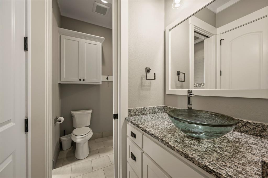 248 Howard Road Valley View, TX 76272 - Photo 24 of 39 a bathroom with a granite countertop sink and a mirror