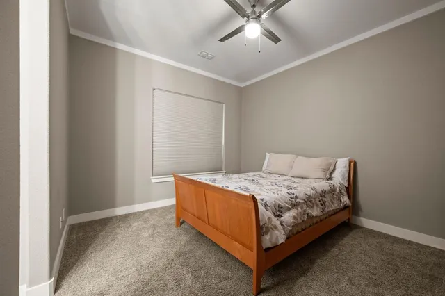 a bedroom with a bed and window