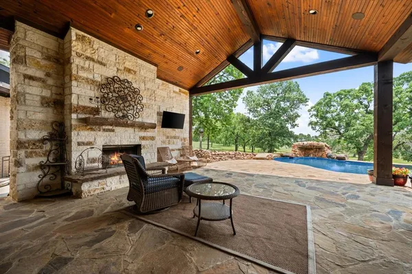 a living room with furniture a fireplace and a large window
