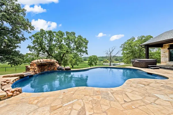 a view of a swimming pool with a yard