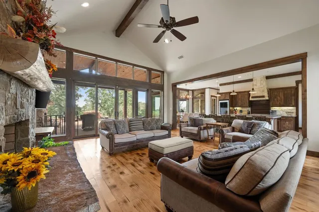 a living room with furniture a fireplace and a chandelier