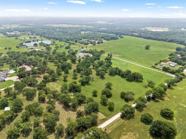 an aerial view of a houses with yard