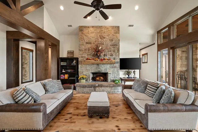 a living room with furniture fireplace and window