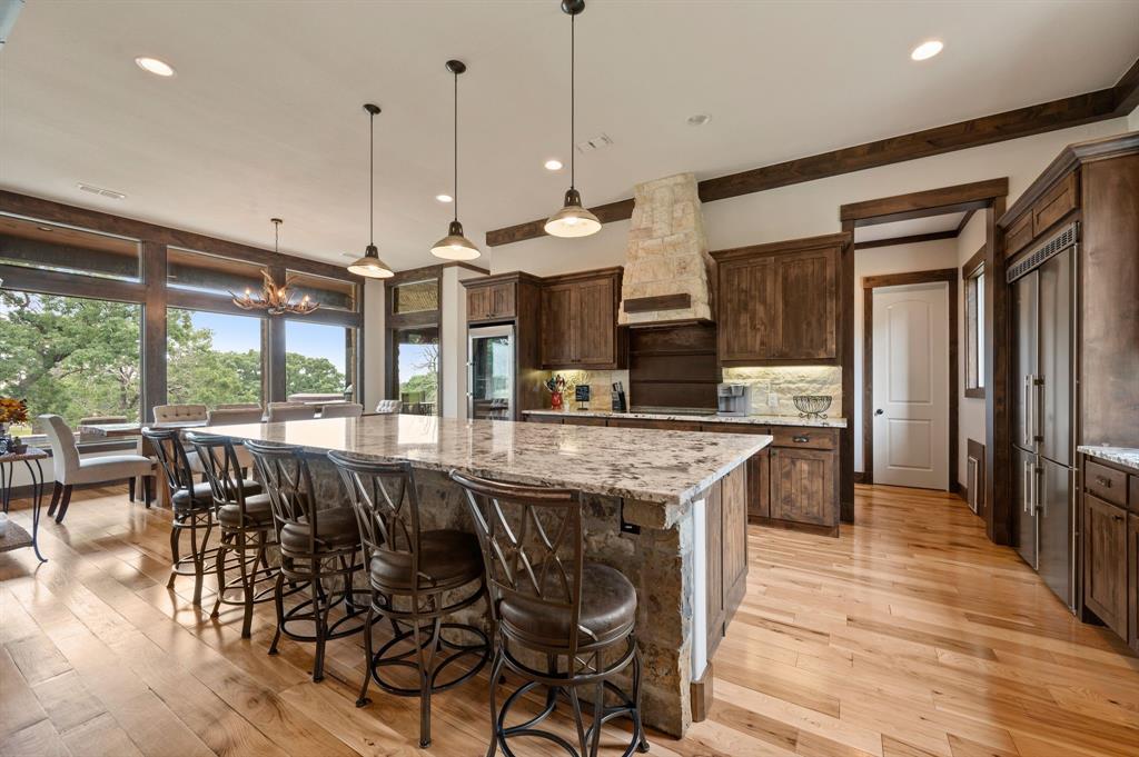 248 Howard Road Valley View, TX 76272 - Photo 7 of 39 a kitchen with stainless steel appliances granite countertop table chairs and wooden floor