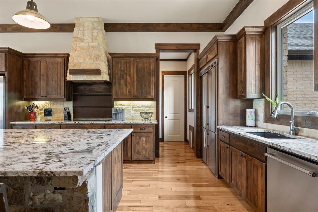 248 Howard Road Valley View, TX 76272 - Photo 9 of 39 a kitchen with kitchen island granite countertop a sink stove and refrigerator