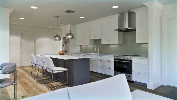 a kitchen with a sink cabinets and wooden floor