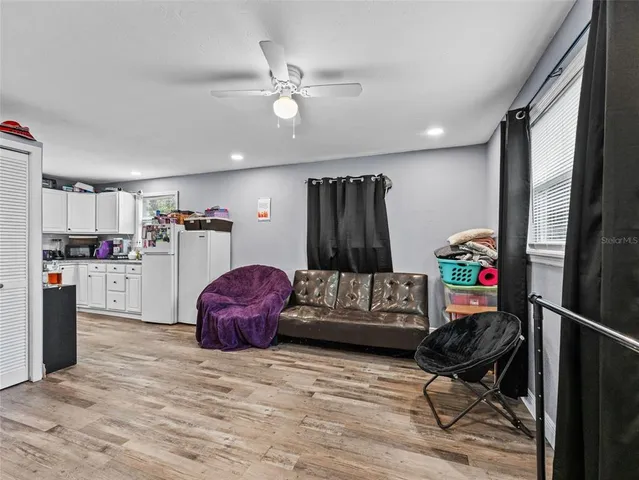 a living room with furniture and kitchen view