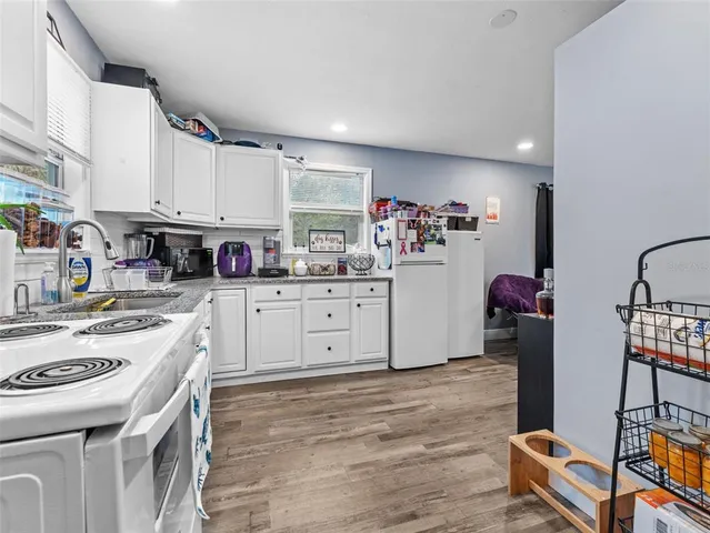 a kitchen with a sink stove and cabinets