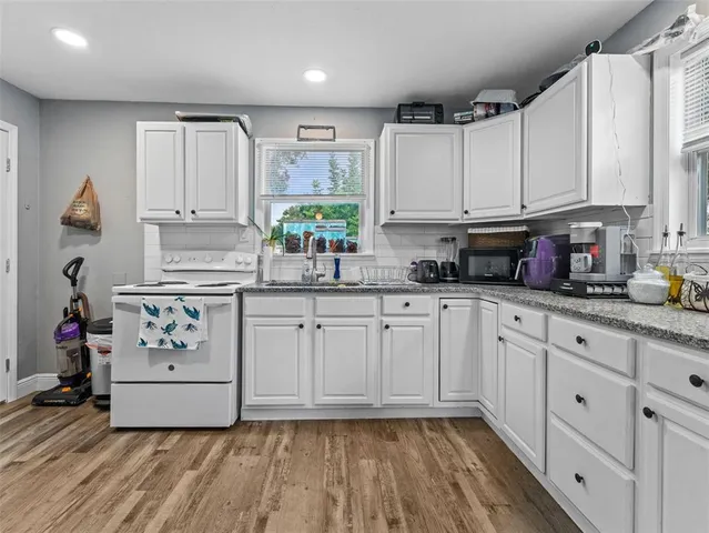 a kitchen with appliances cabinets and a counter top space