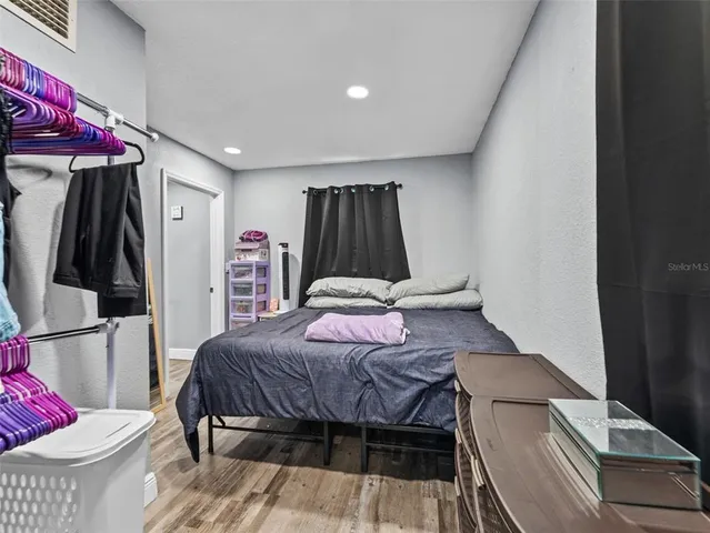 a bedroom with a bed and a couch