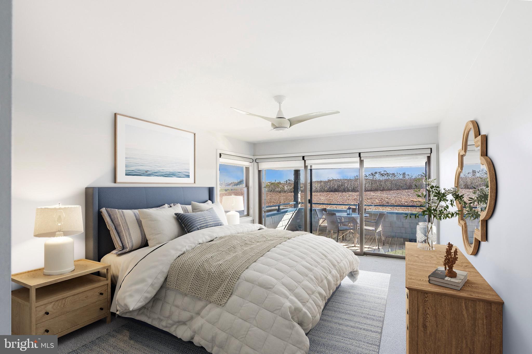 1001 Ocean Avenue, Unit 1017 Ship Bottom, NJ 08008 - Photo 11 of 31 a bedroom with a large bed and a chandelier