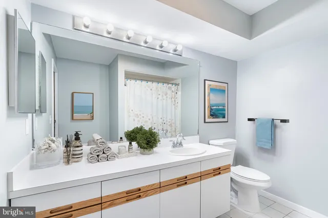 a bathroom with a sink a toilet and mirror