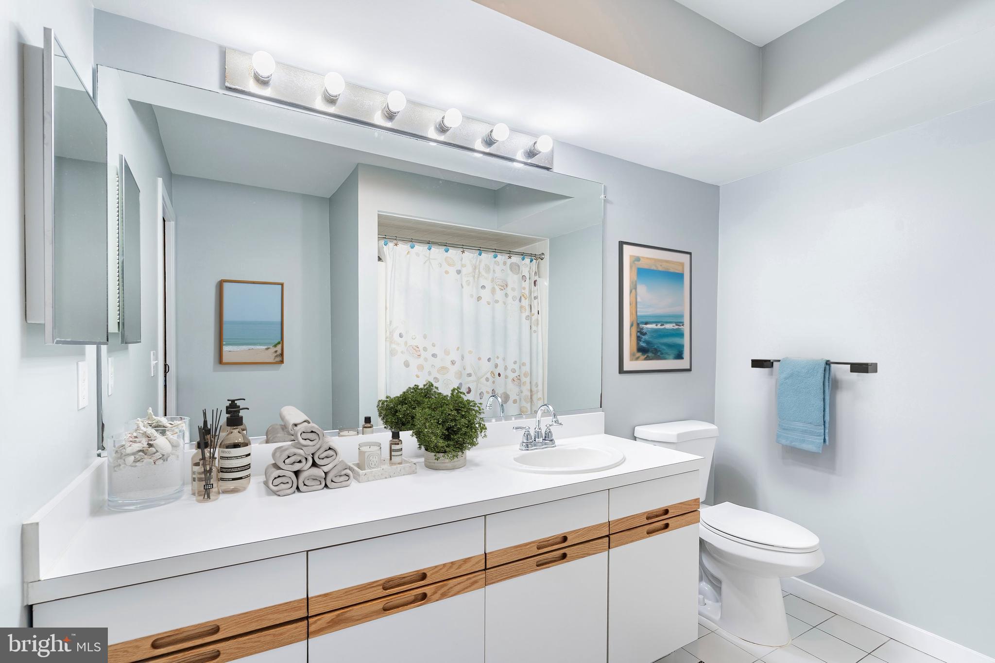 1001 Ocean Avenue, Unit 1017 Ship Bottom, NJ 08008 - Photo 12 of 31 a bathroom with a sink a toilet and mirror