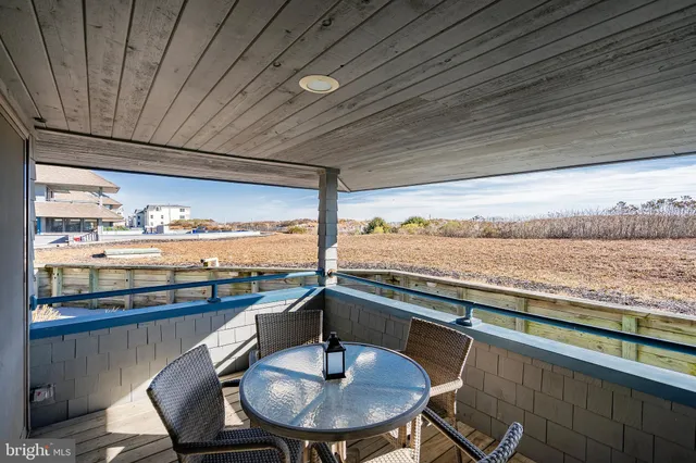 a view of a balcony dining table and chairs