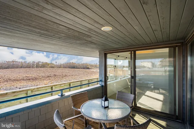 a view of a balcony dining table and chairs