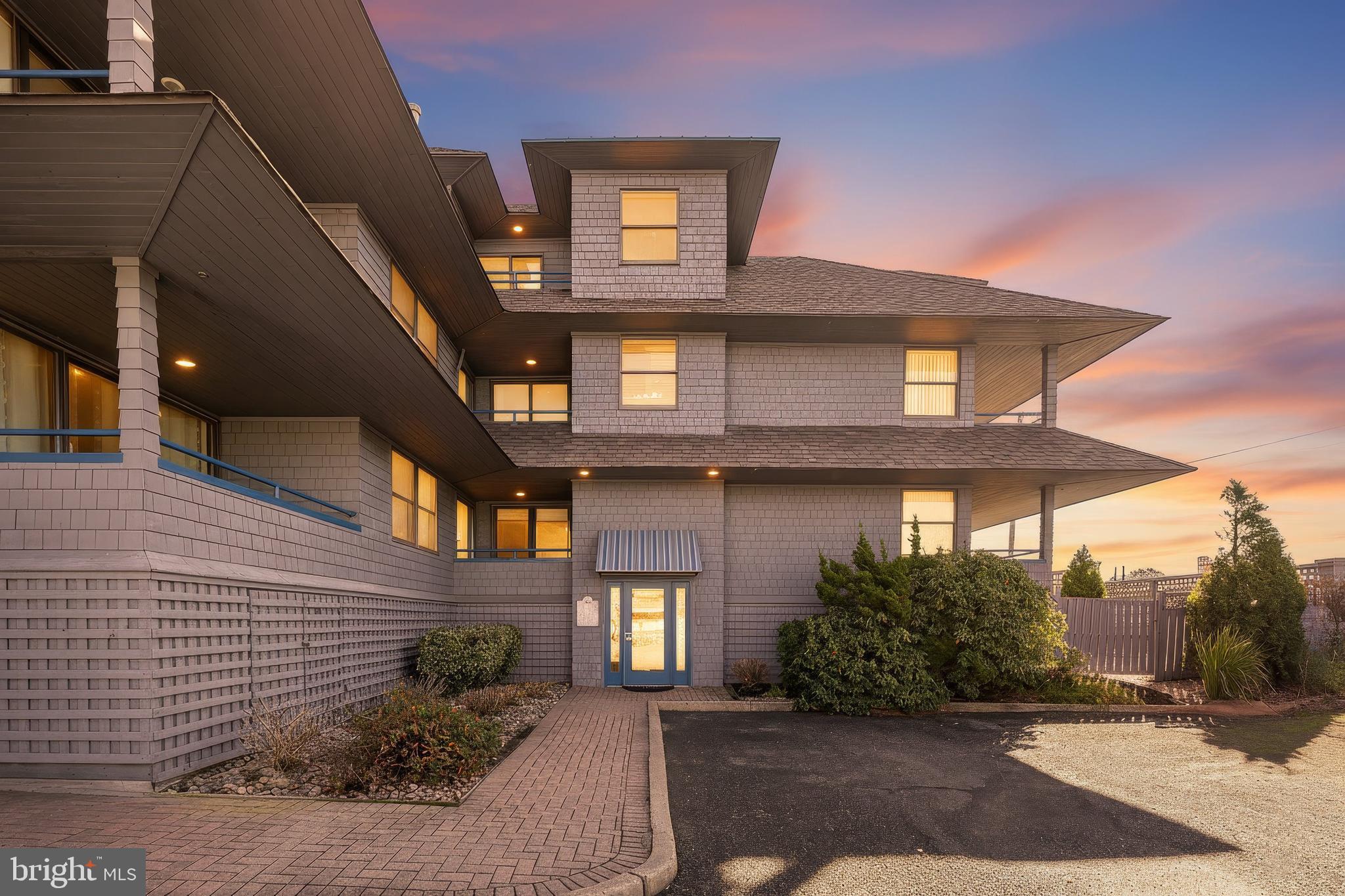 1001 Ocean Avenue, Unit 1017 Ship Bottom, NJ 08008 - Photo 2 of 31 a front view of a house with a yard