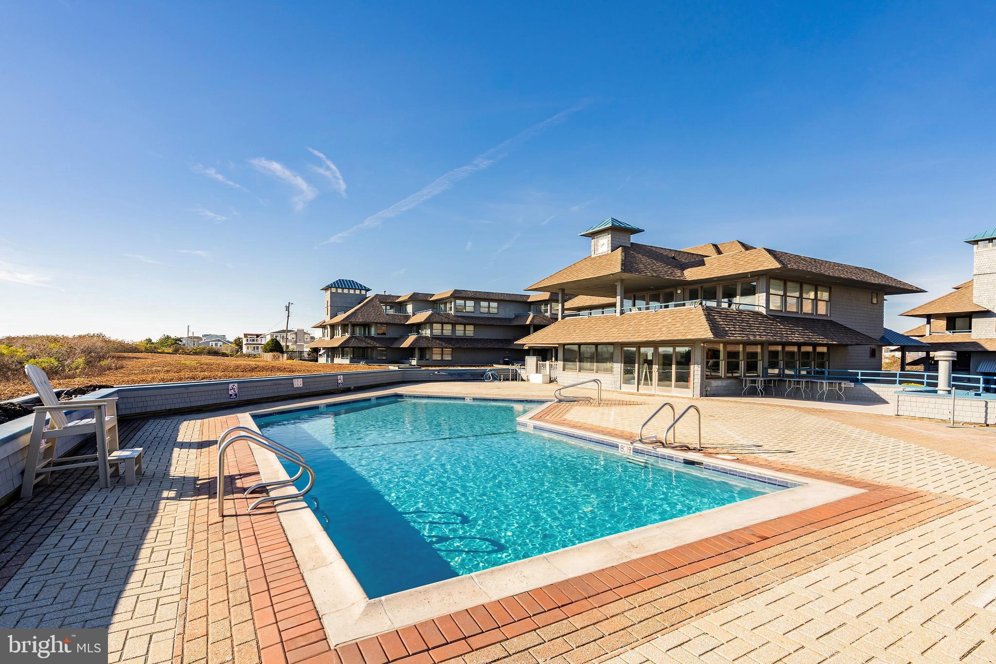 1001 Ocean Avenue, Unit 1017 Ship Bottom, NJ 08008 - Photo 23 of 31 a view of a house with pool and chairs