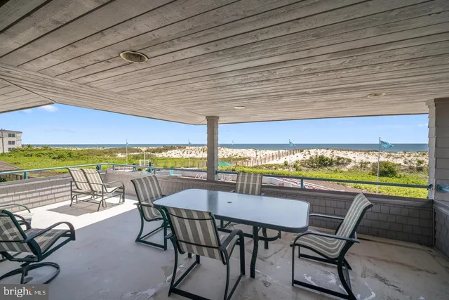 a view of a chairs and table in the balcony