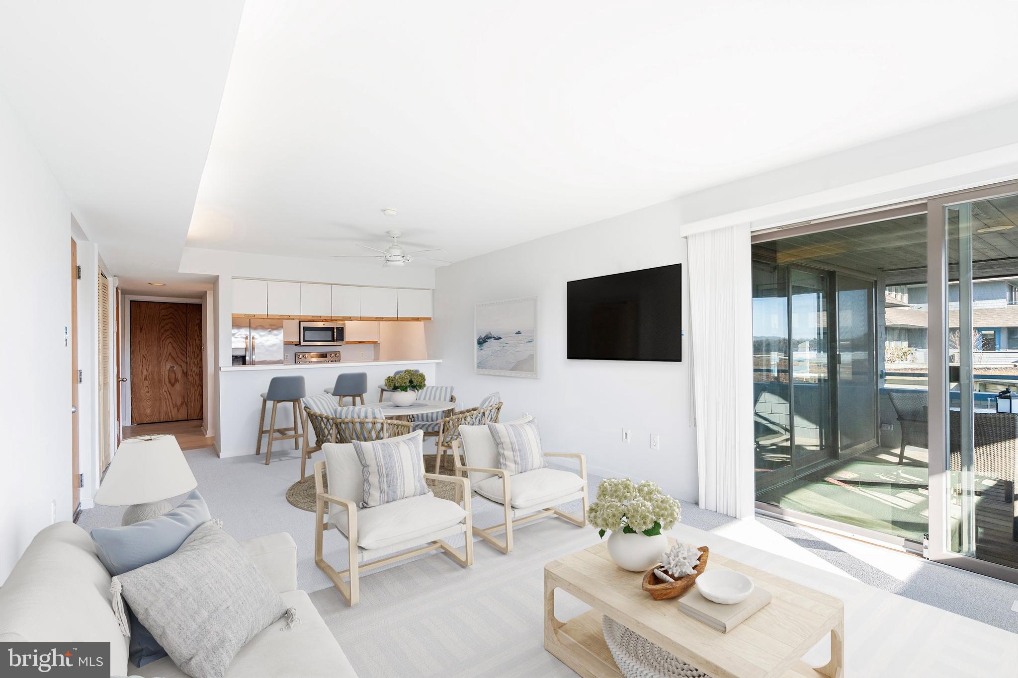 1001 Ocean Avenue, Unit 1017 Ship Bottom, NJ 08008 - Photo 8 of 31 a living room with furniture and a flat screen tv