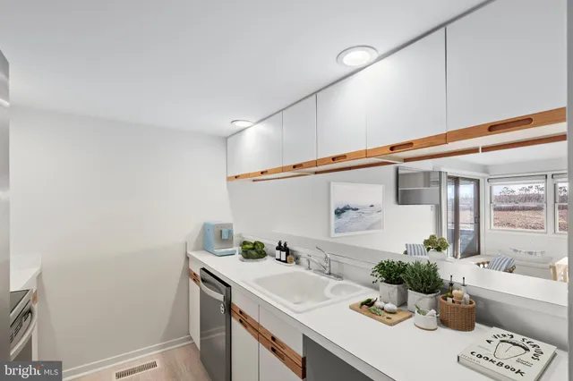 a spacious bathroom with a granite countertop sink and a mirror