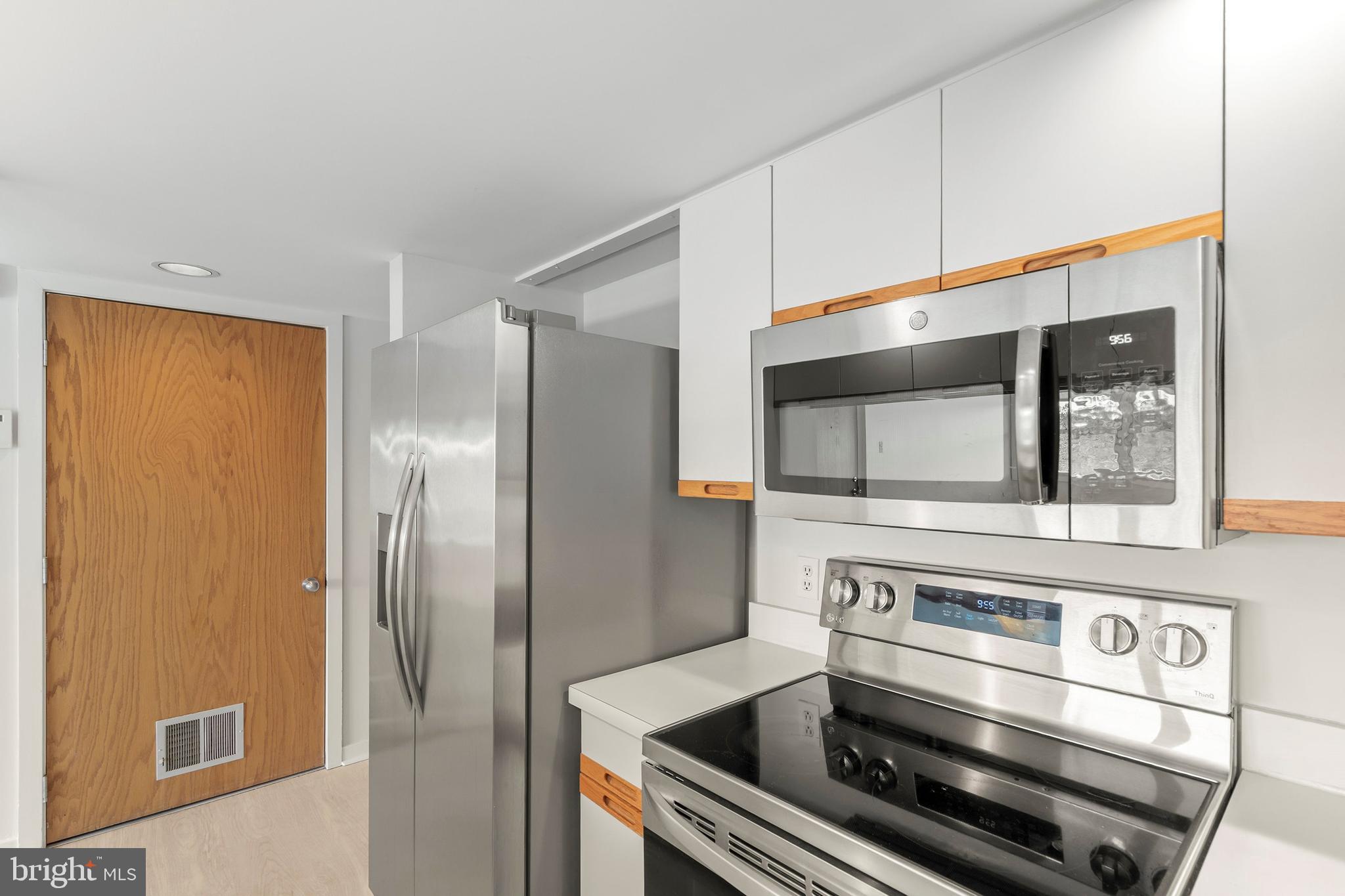 1001 Ocean Avenue, Unit 1017 Ship Bottom, NJ 08008 - Photo 10 of 31 a stove top oven sitting inside of a kitchen