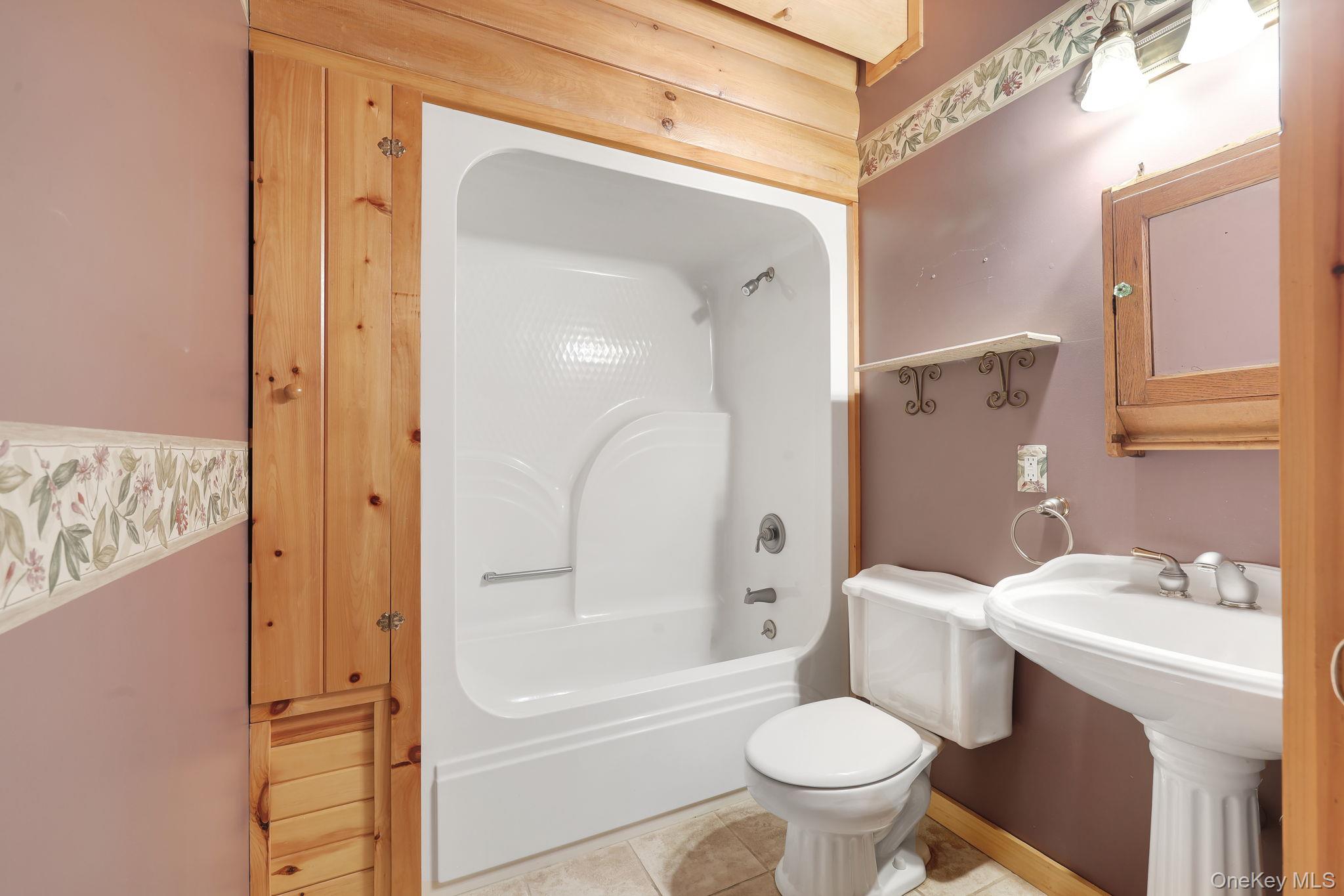 230 Post Road Slate Hill, NY 10973 - Photo 20 of 26 This bathroom has a shower/tub combination and a pocket door for privacy.