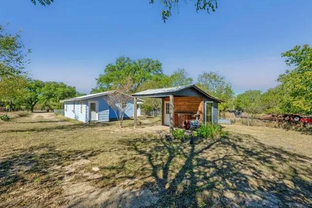 a front view of a house with a yard and a garage