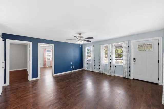 wooden floor in an empty room with a window