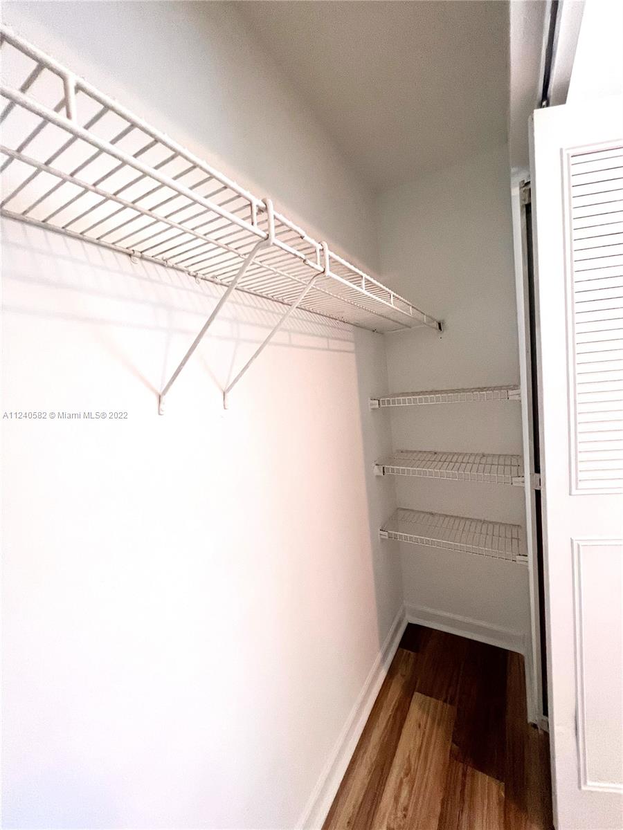 22795 Southwest 66th Avenue, Unit 206 Boca Raton, FL 33428 - Photo 15 of 29 a view of walk in closet with empty racks