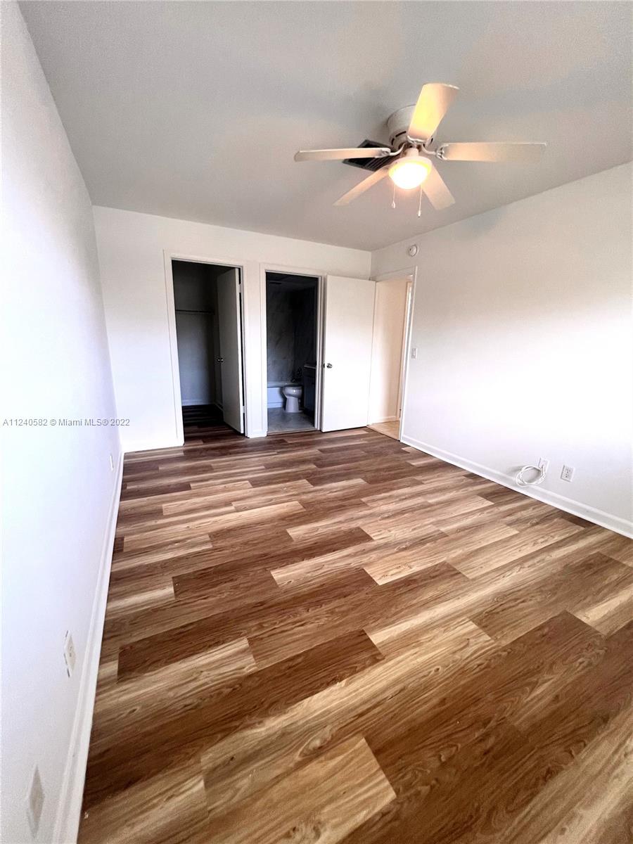 22795 Southwest 66th Avenue, Unit 206 Boca Raton, FL 33428 - Photo 20 of 29 a view of an empty room with kitchen and a window