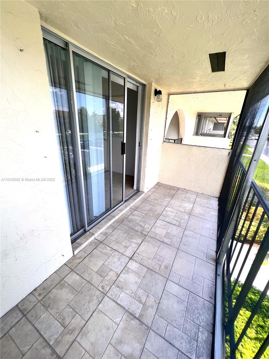 22795 Southwest 66th Avenue, Unit 206 Boca Raton, FL 33428 - Photo 26 of 29 a view of entryway with a door and wooden floor