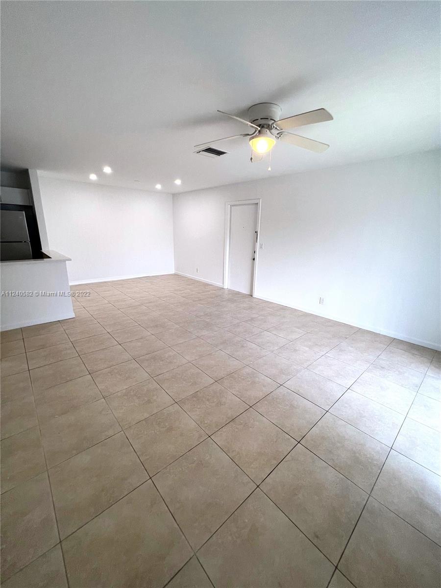 22795 Southwest 66th Avenue, Unit 206 Boca Raton, FL 33428 - Photo 4 of 29 a view of an empty room and a ceiling fan