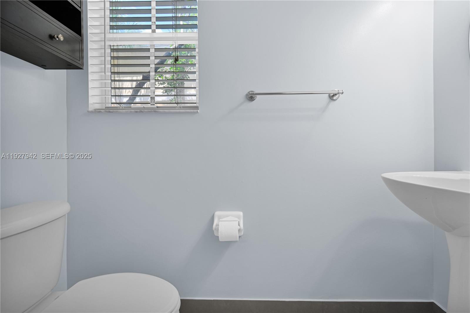 12832 Southwest 30th Street, Unit 118 Miramar, FL 33027 - Photo 11 of 29 a bathroom with a toilet a sink and mirror